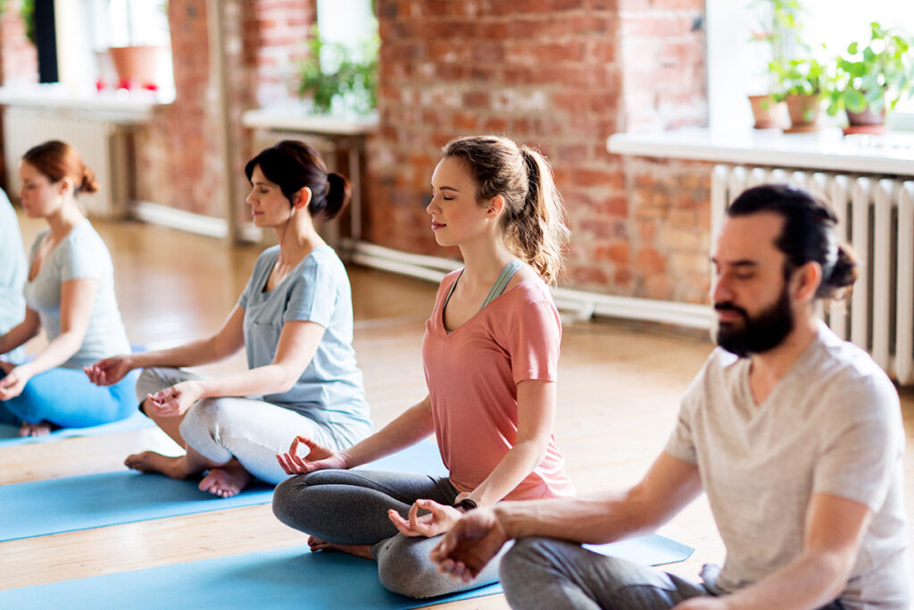 A group yoga class is happening at Elevate Point. It's part of a holistic treatment program.