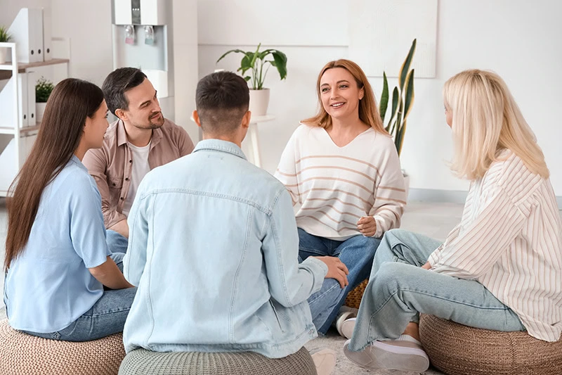 People participate in therapy at a drug rehab center.