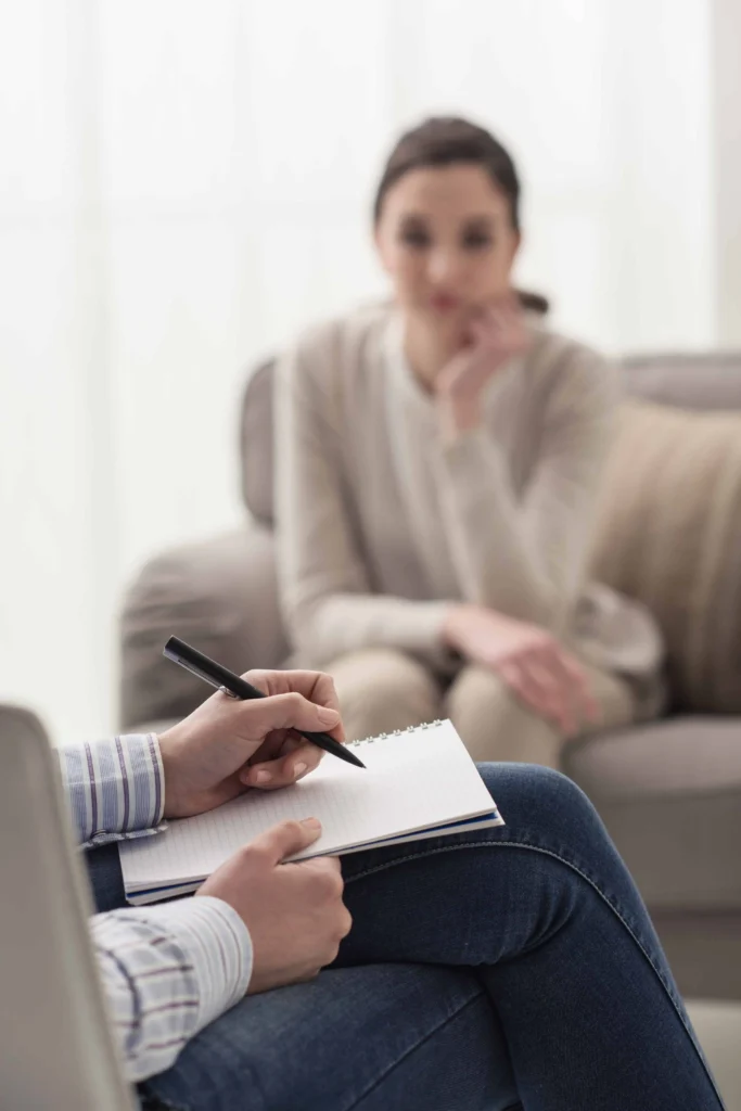 A woman participates in therapy at a drug rehab center.