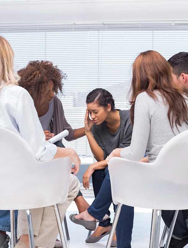 People participate in therapy at a heroin rehab center.