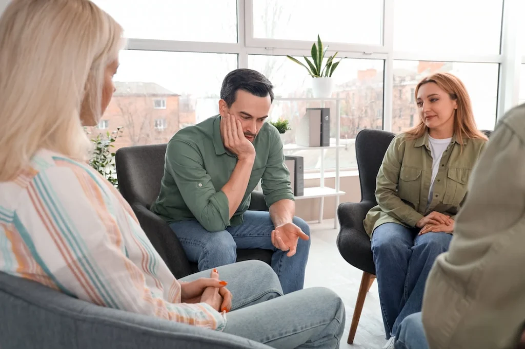 People participate in therapy at a PTSD treatment center.